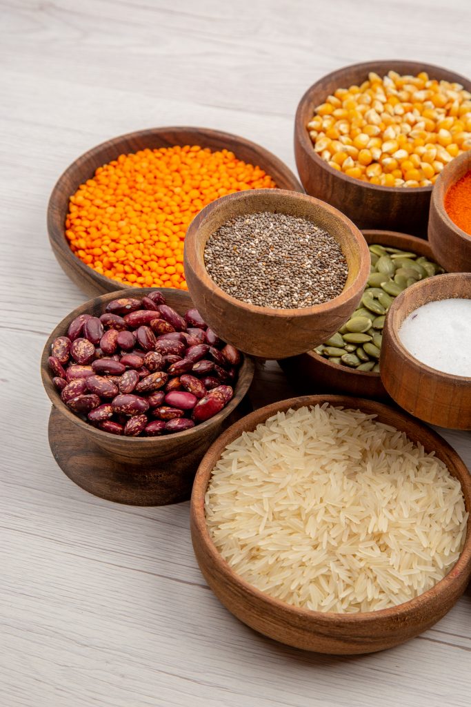 a group of bowls of different types of grains and pulses